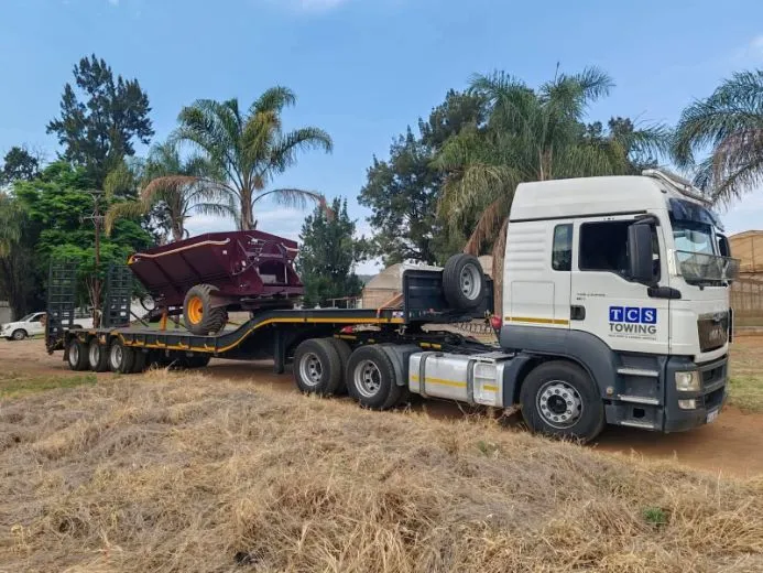 Heavy-duty truck hauling agricultural implement