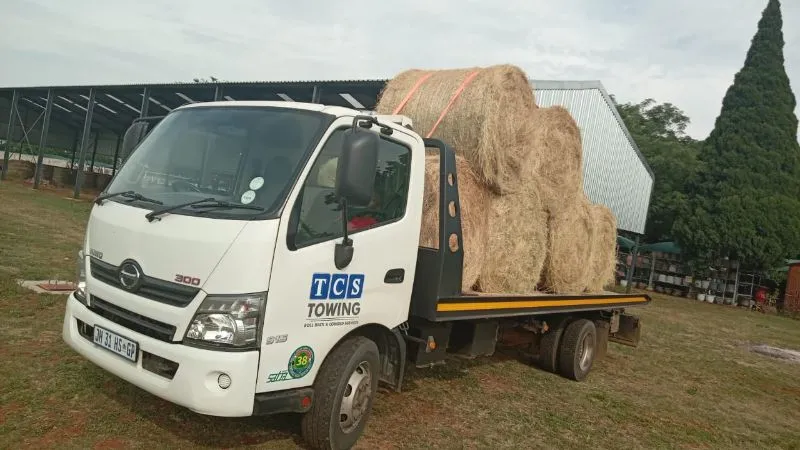 Flatbed truck loaded with hay bales
