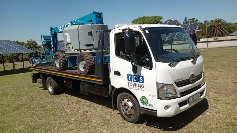Flatbed truck with blue boom lift